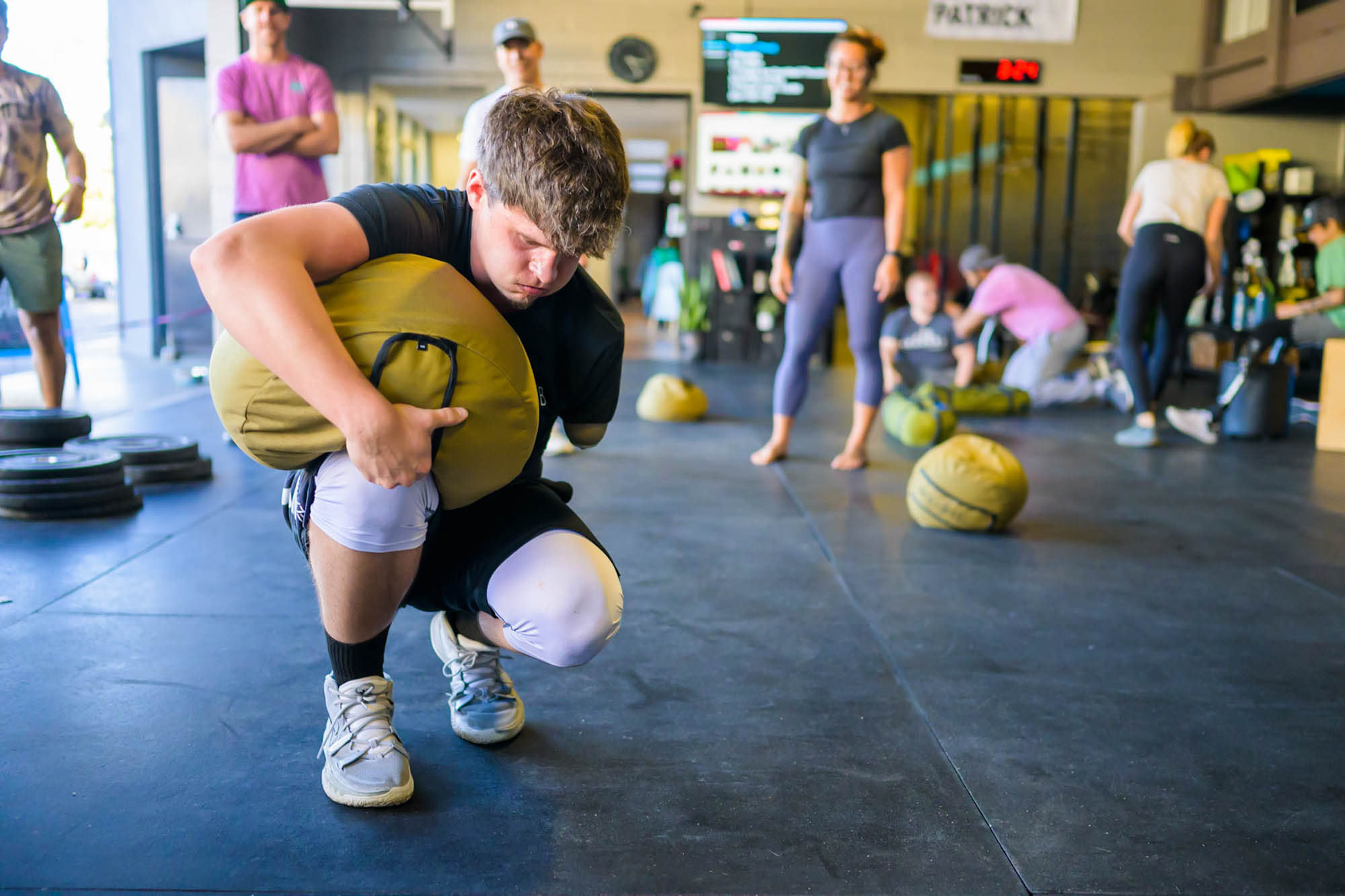 Forge attendee picking up a sand bag