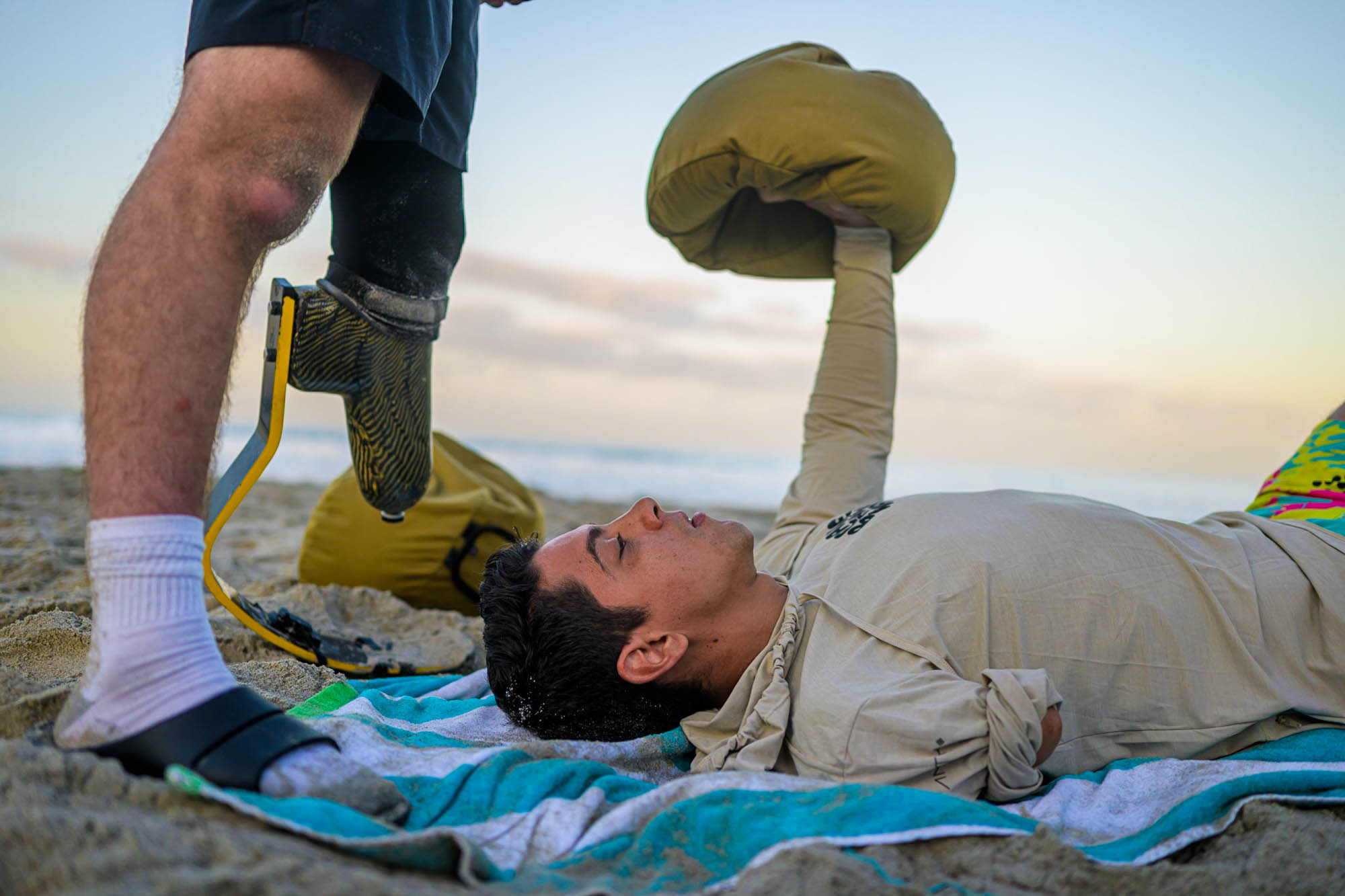 Forge attendee lifting a sandbag over his head