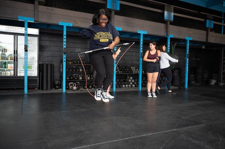 Using a RX Smart Gear adaptive rope, Beautifully Flawed attendee Joy smiles jumping rope with only her one arm.