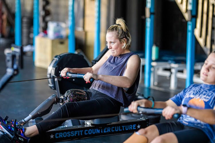 Emma June, right leg amputee, gives it her all on the rowing machine in the CrossFit gym.