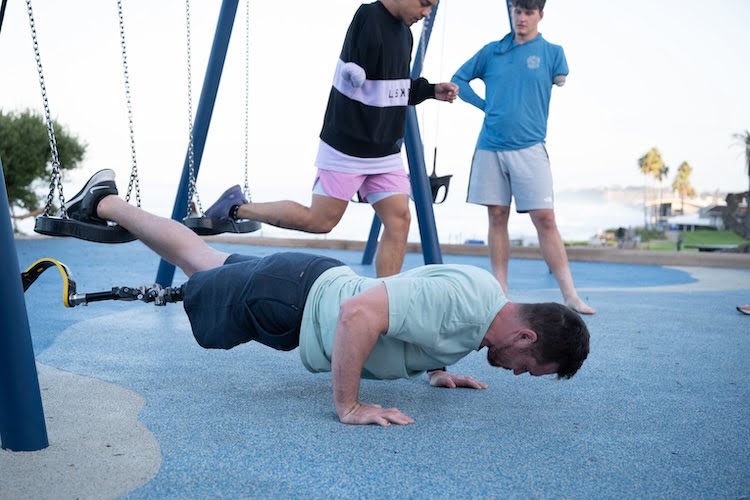 Forge attendee and leg amputee Josh doing push ups during a workout.