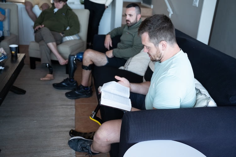 Forge leader Josh sharing a message and reading a verse from the Bible during the group session.