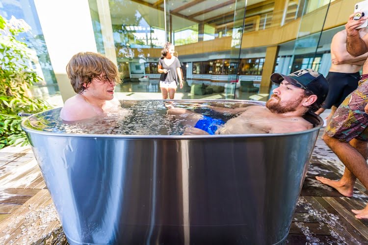 Two Forge attendees sit in the cold ice bath, an activity which helps promote the importance of physical health in attendees.
