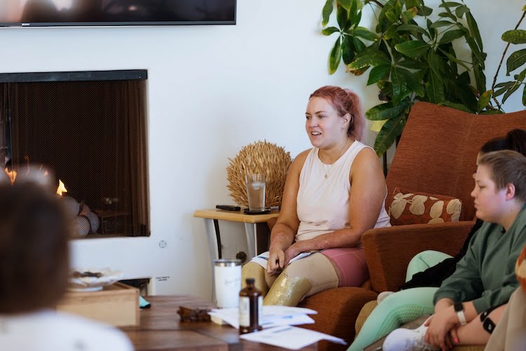 Beautifully Flawed leader and quad amputee Callie shares a message and her story to the other girls during a group session.